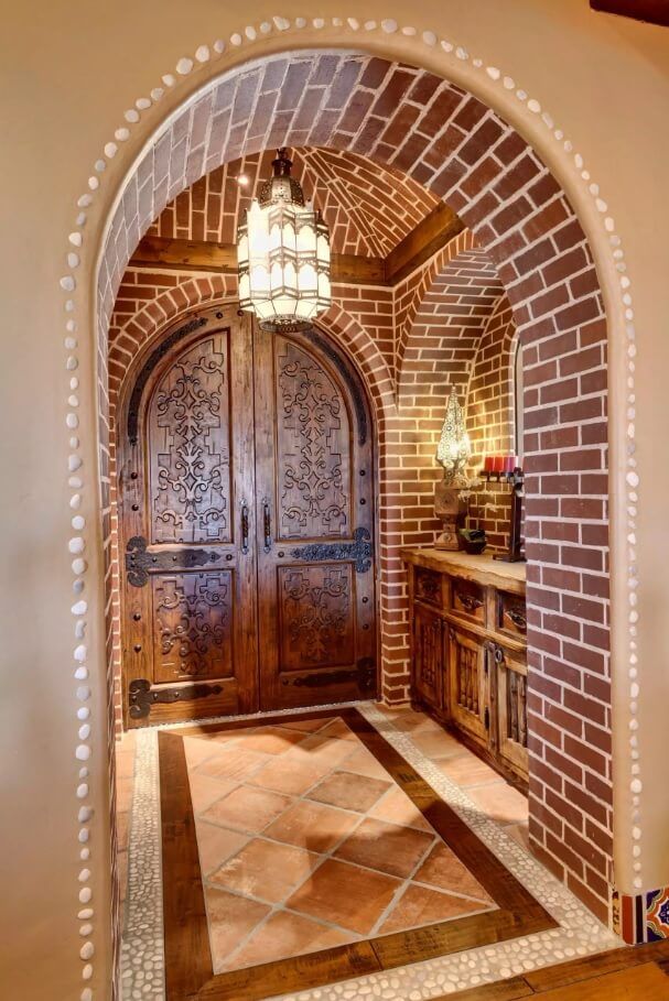 Arched entry door carved in medieval thematic