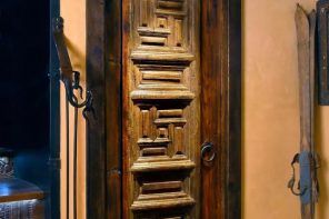 Peculiarly carved door in the rustic designed interior
