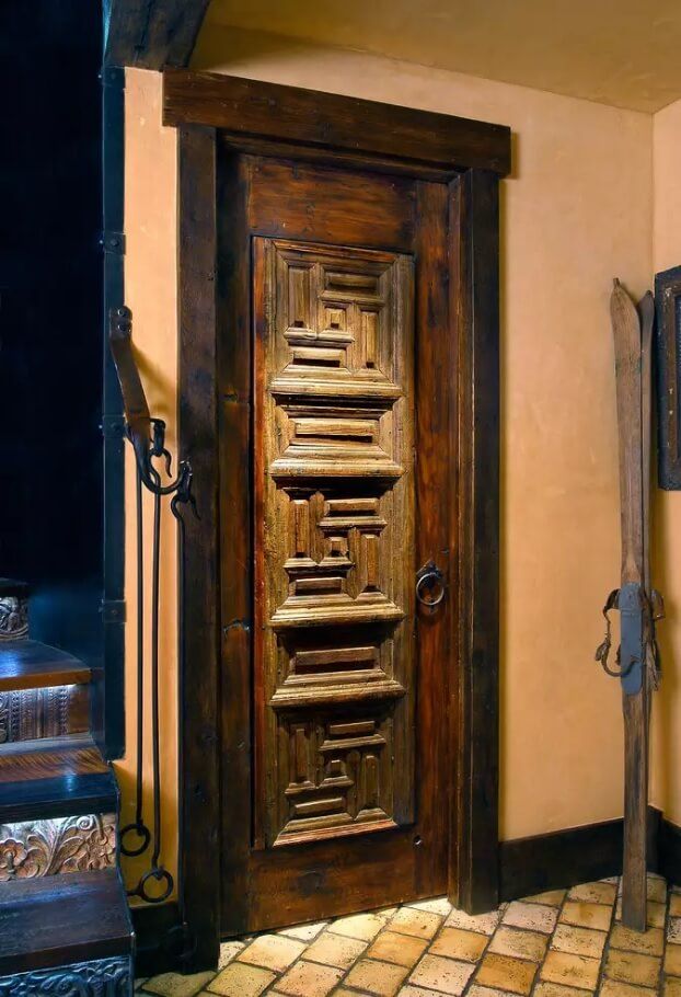 Peculiarly carved door in the rustic designed interior