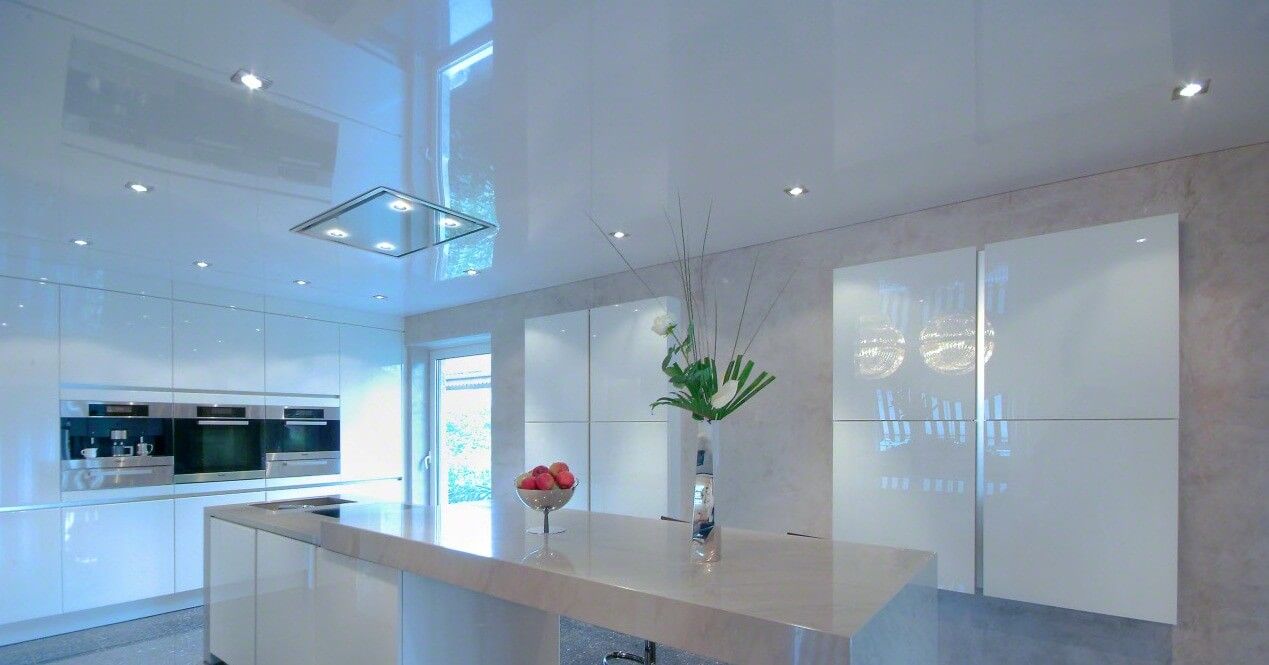 Spectacular white glossy surface of the PVC ceiling at the kitchen