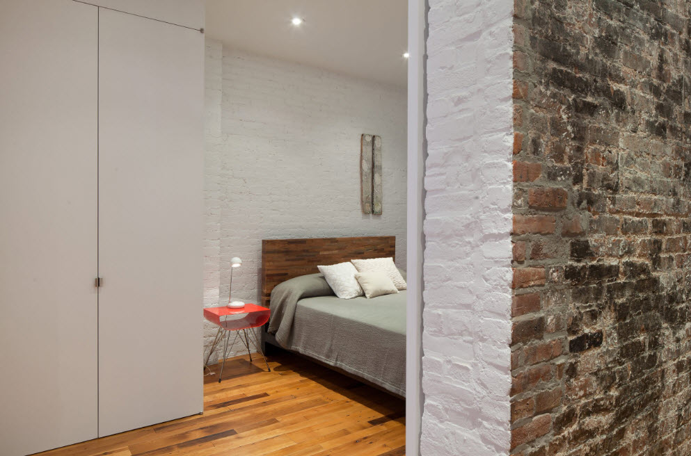 brickwork as the most magnetizing interior detail of the bedrom with large wardrobe-cabinet