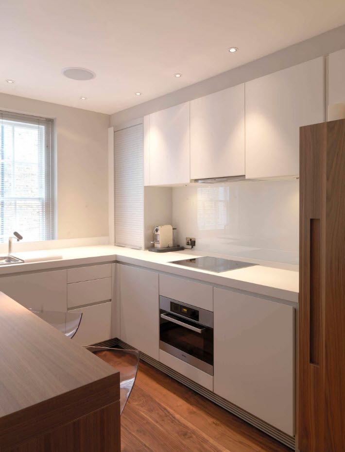 White modular kitchen set with white facades in the small apartment
