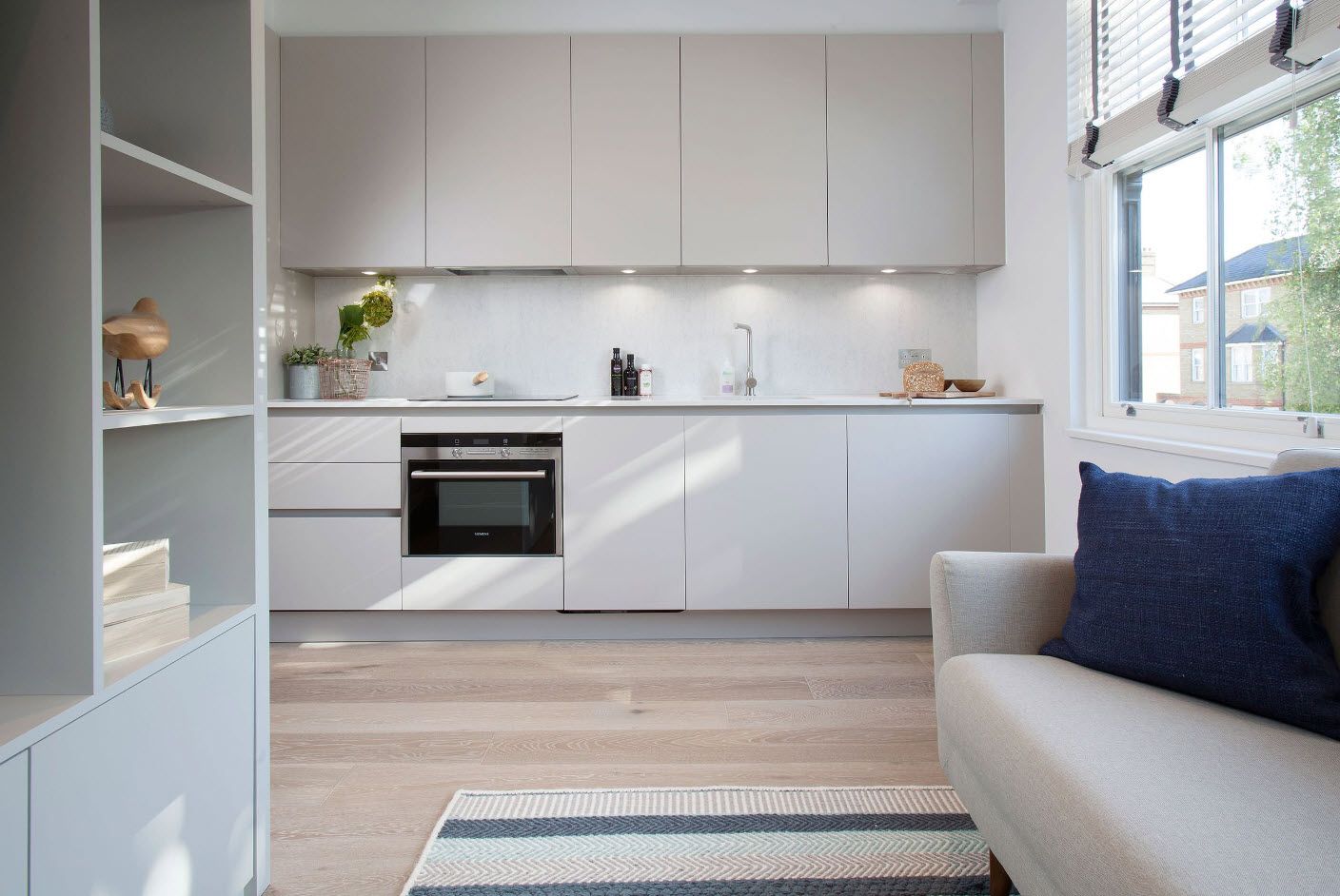 Matted white surfaces of white kitchen facades of minimalistic kitchen