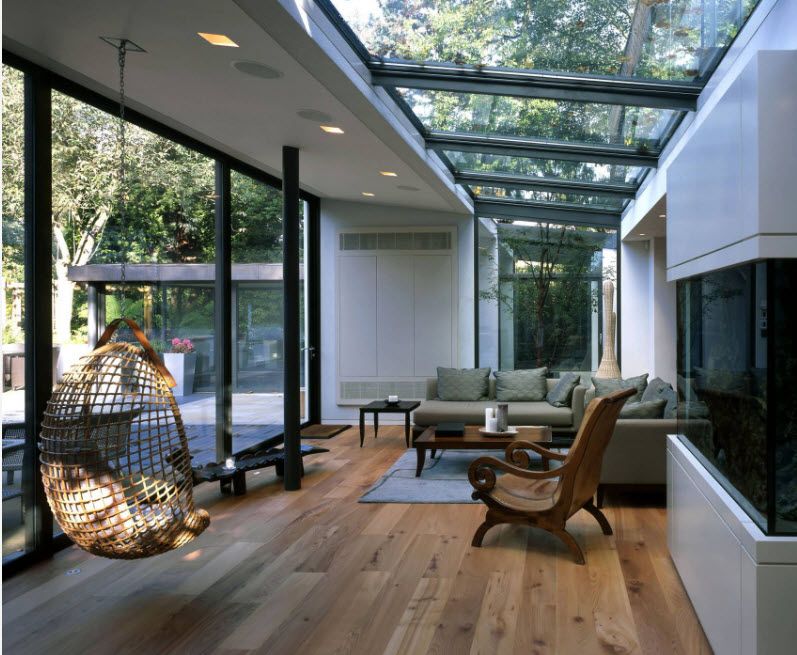 Suspended Bubble Chair. Modern Interior Ideas. Glass roof and cage carcass of the hangin chair in the ultramodern house