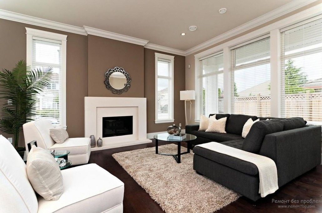 Brown accent wall with the mirror and fireplace