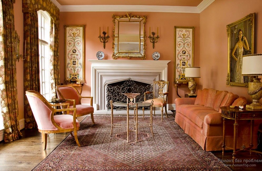 Classic style in the warm peachy living room with the fireplace and golden frames of paints