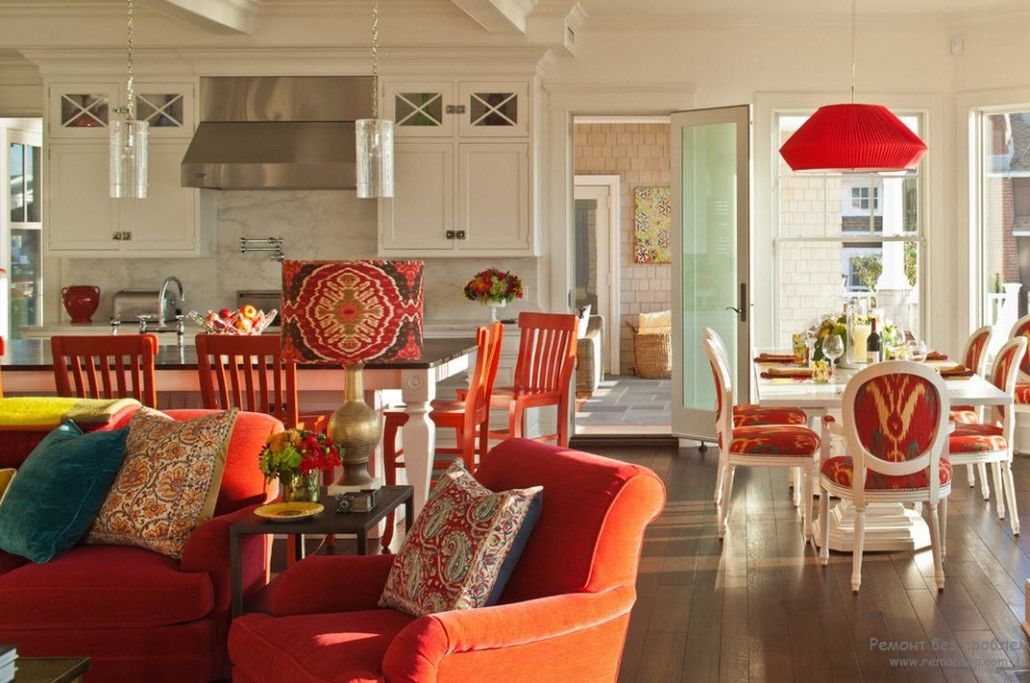 Orange color of furniture in the Classic designed open space in the private cottage