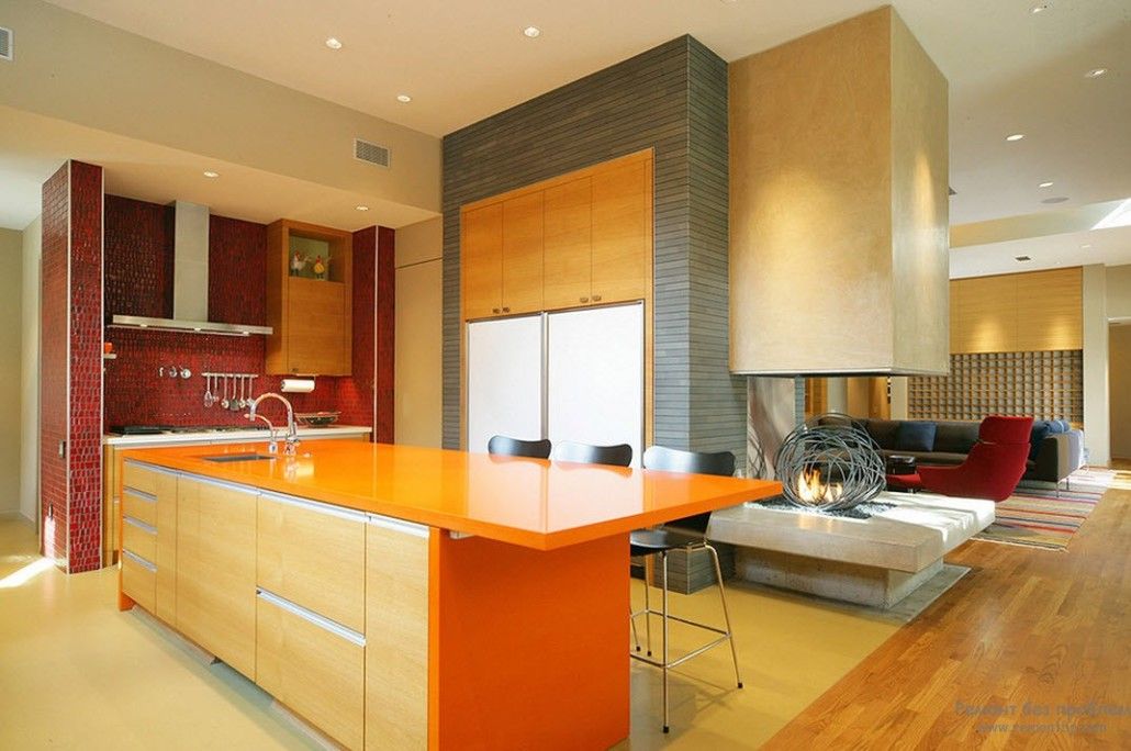 Unexpected orange glossy kitchen island in the spacious Modern and hi-tech styled room