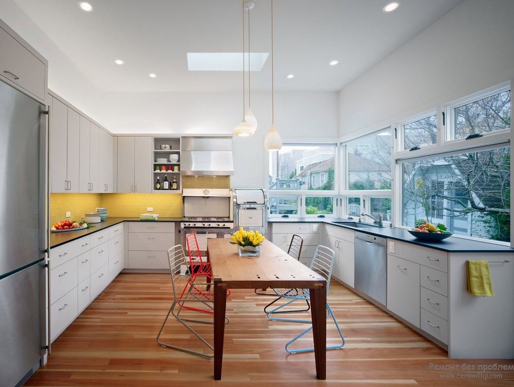 Yellow glossy LED-enlighted splashback in the modern styled kitchen
