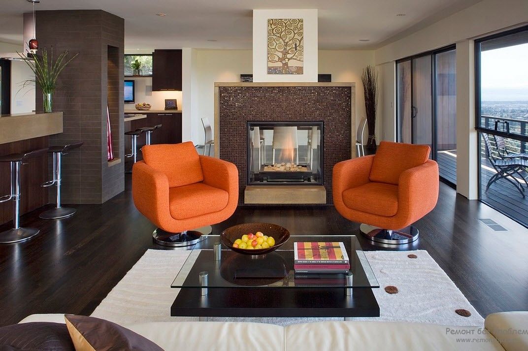 Business atmosphere in the living room with two swivel orange armchairs