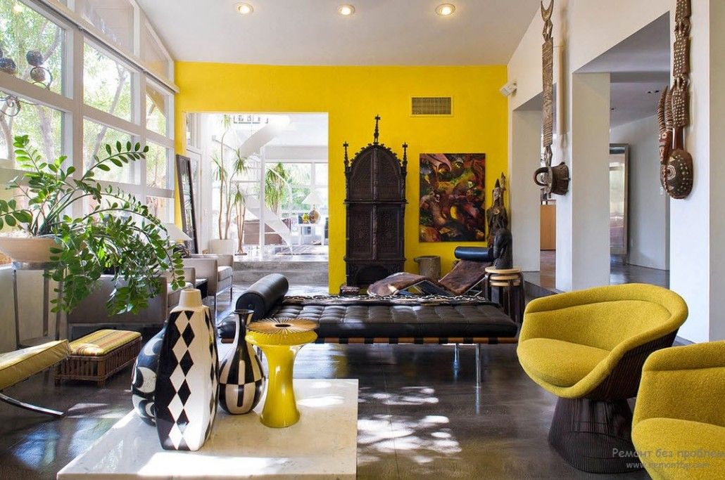 Bright yellow accent wall in African styled living room
