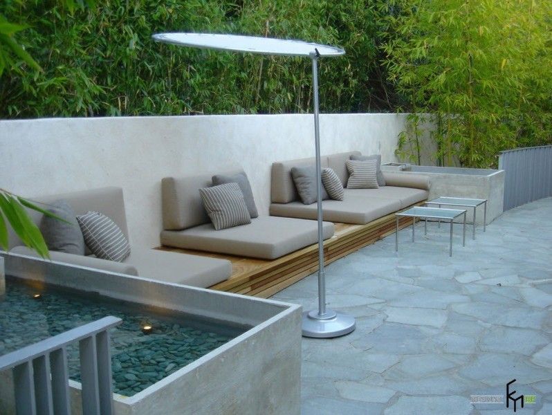 Poolside recreational zone with the wooden platform and chaise lounge there