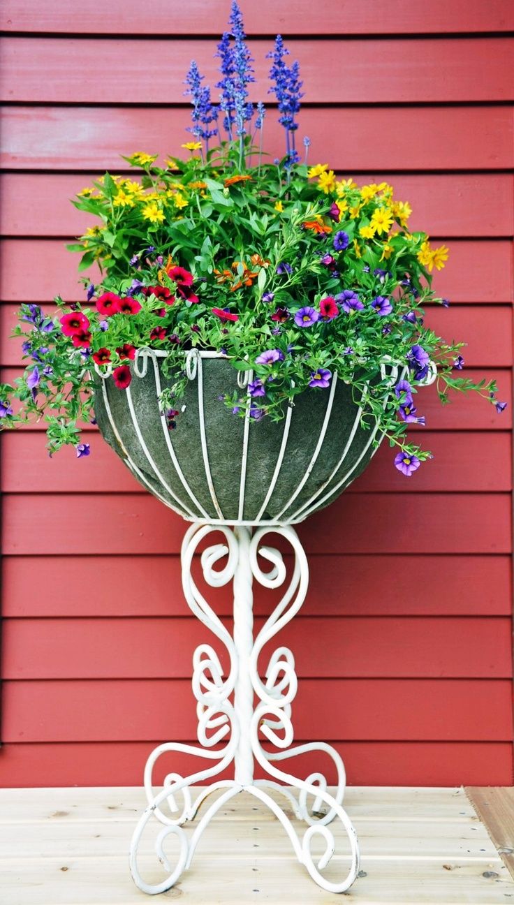 White forged bed stand hanging at the house' facade