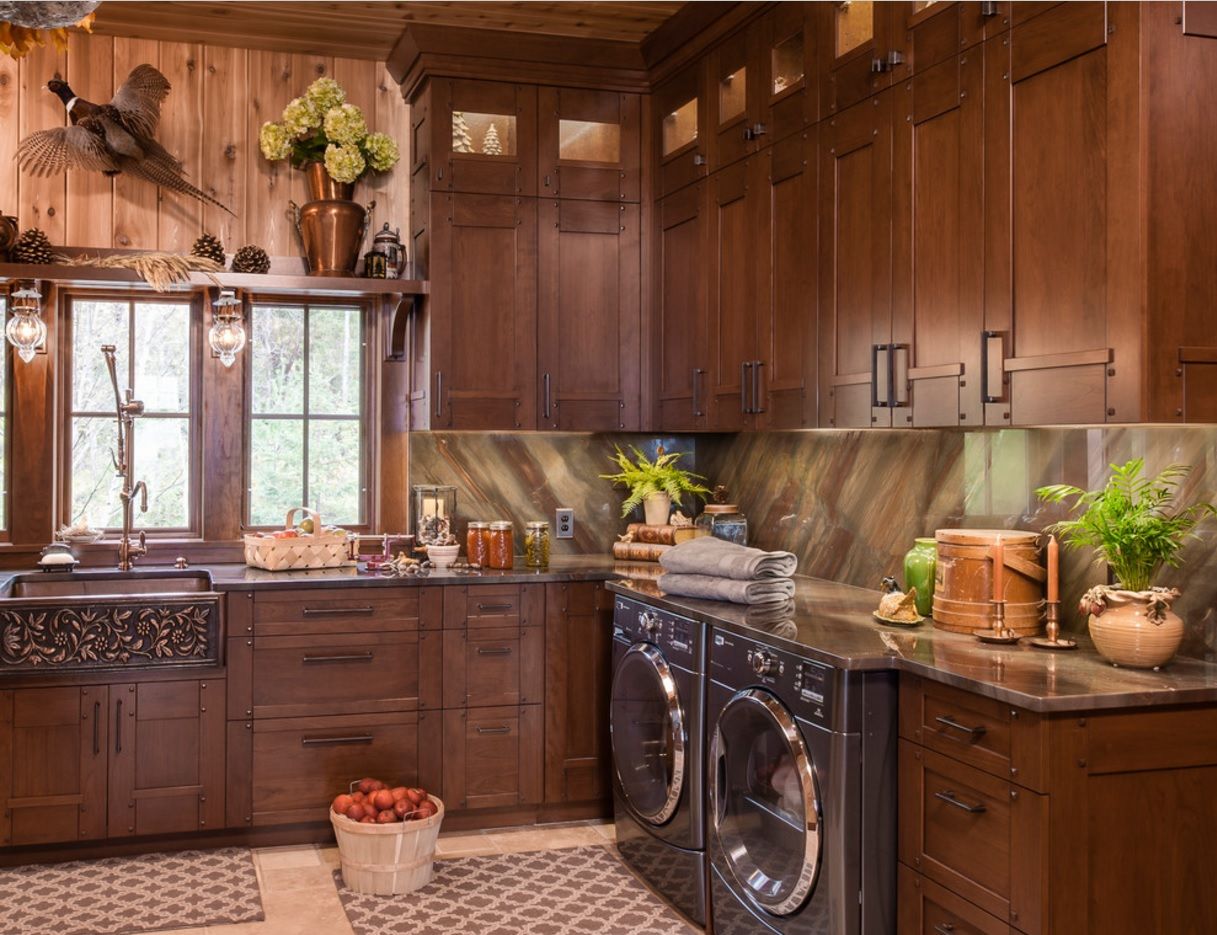 Dark kitchen interior successfuly took the combination of natural materials and modern home appliances