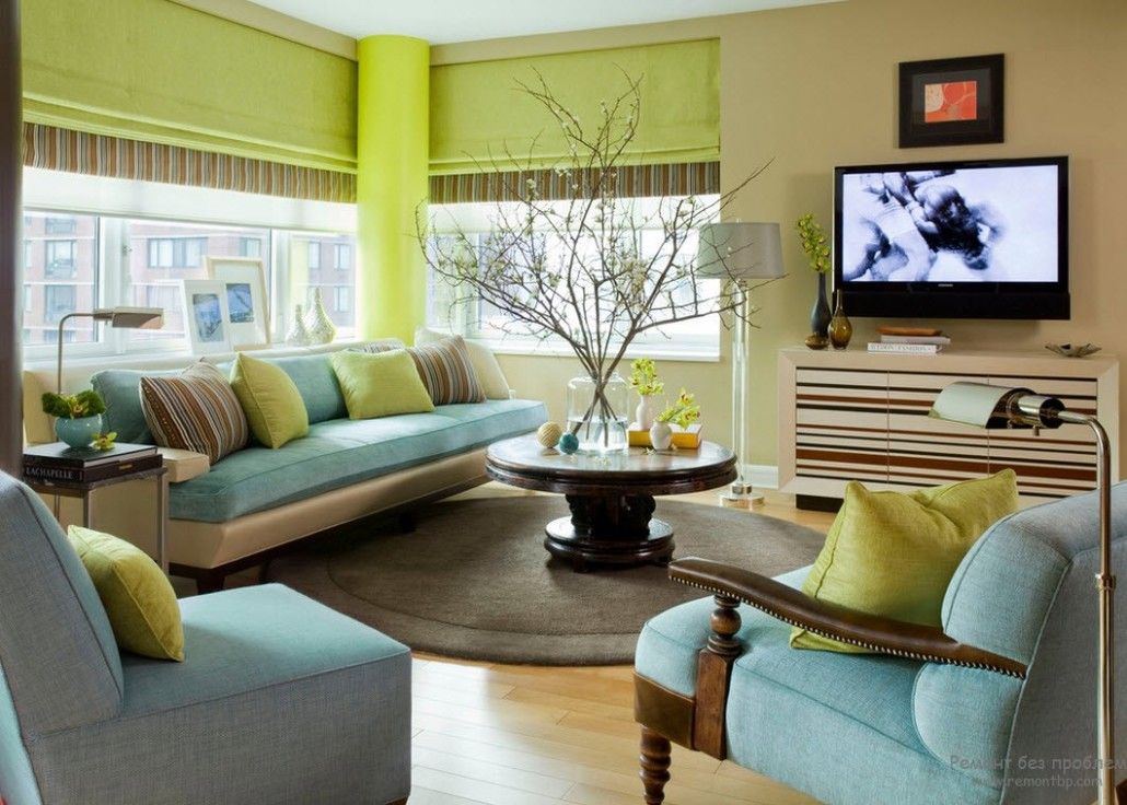 Salad green walls and pale blue furniture mix in the large living room