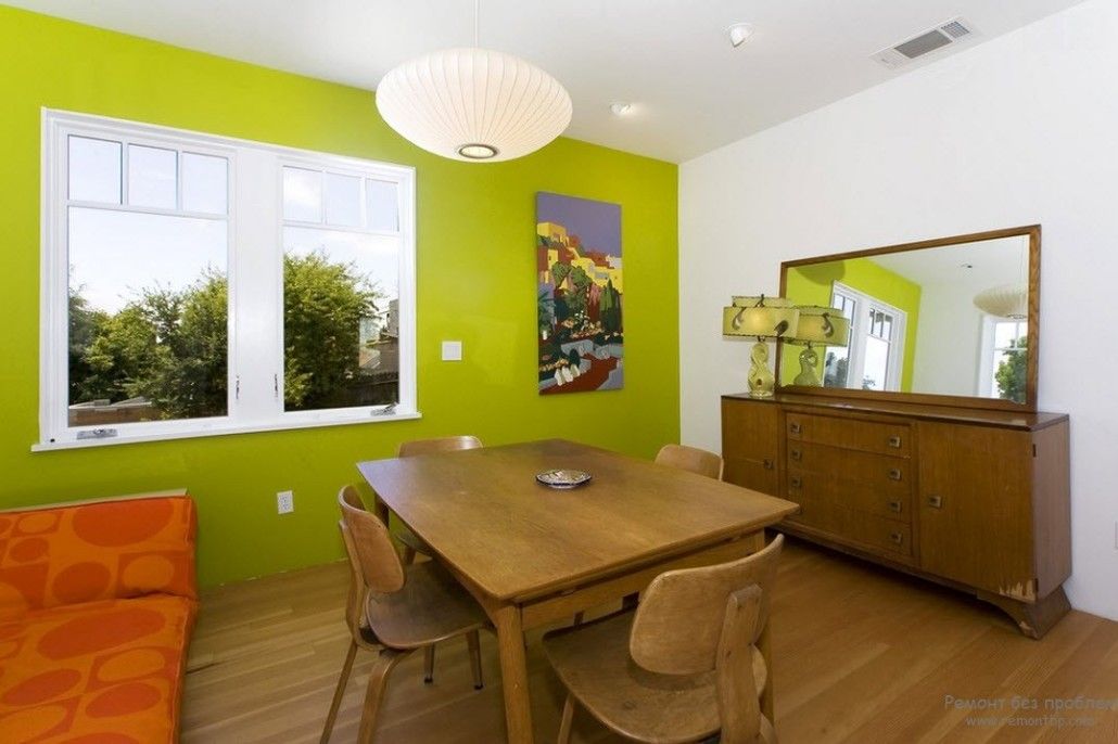 Green accent wall for the dining room and the wooden furniture set in Eco styled kitchen
