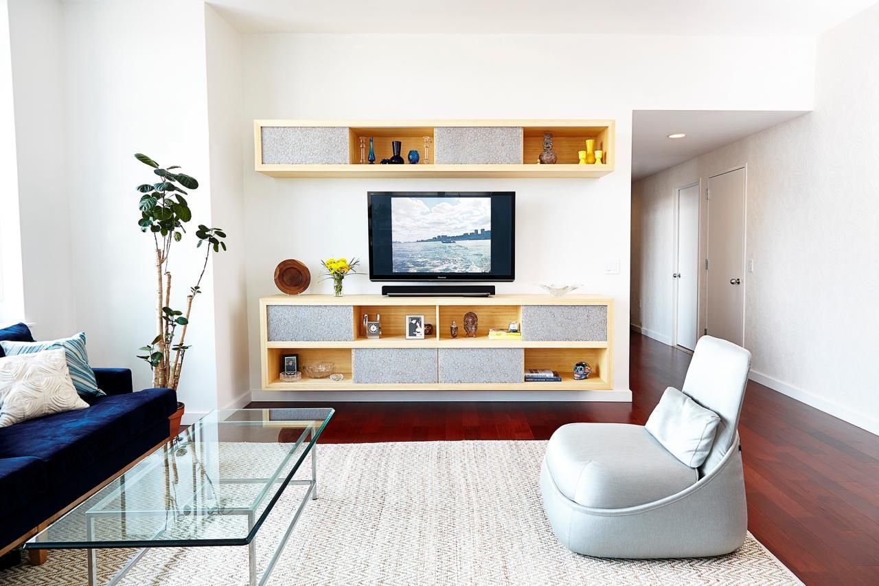 Successful and flashy shelving in white for the Scandi styled room with glass coffee table