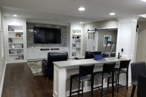 Modern styled home theater in white with island bar