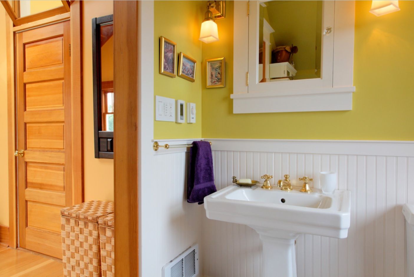 Bathroom with Wainscoting Design Ideas. Yellow wall paint and white matted wooden panels