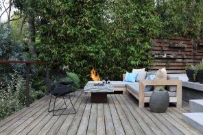 Backyard BBQ zone with gray wooden planked flooring