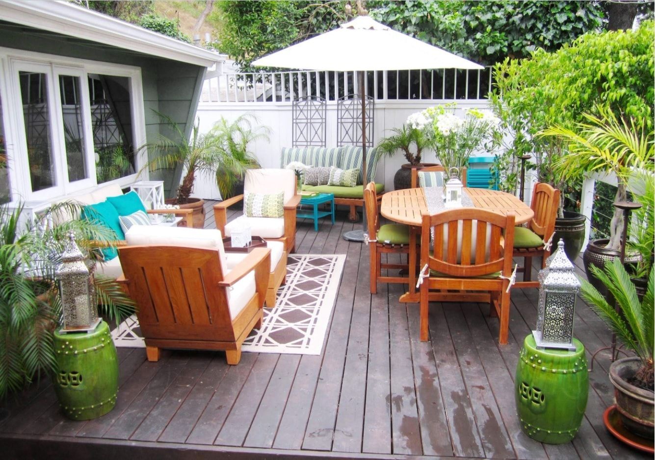 Patio zone with cozy wooden armchairs that transform into sunbeds