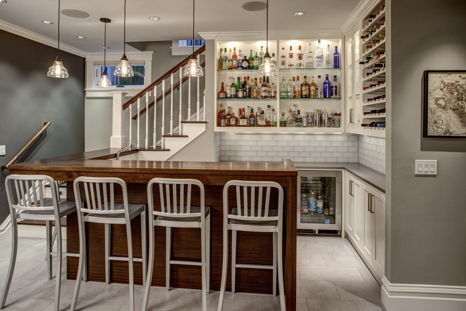 dark wooden kitchen island in the form of bar count in the white designed classic interior