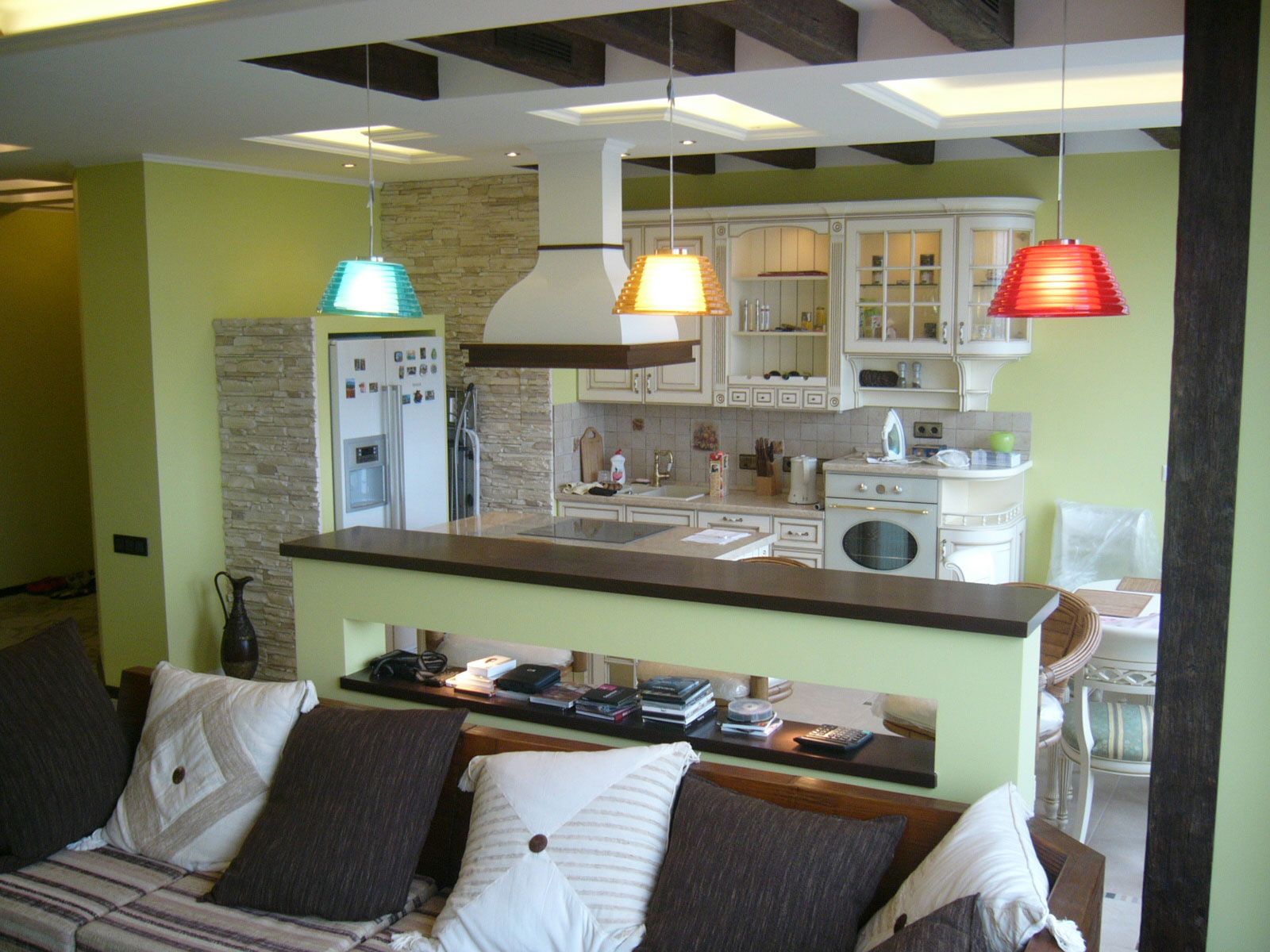 Lime wall color theme in the living room combined with kitchen zone and separated by the bar island
