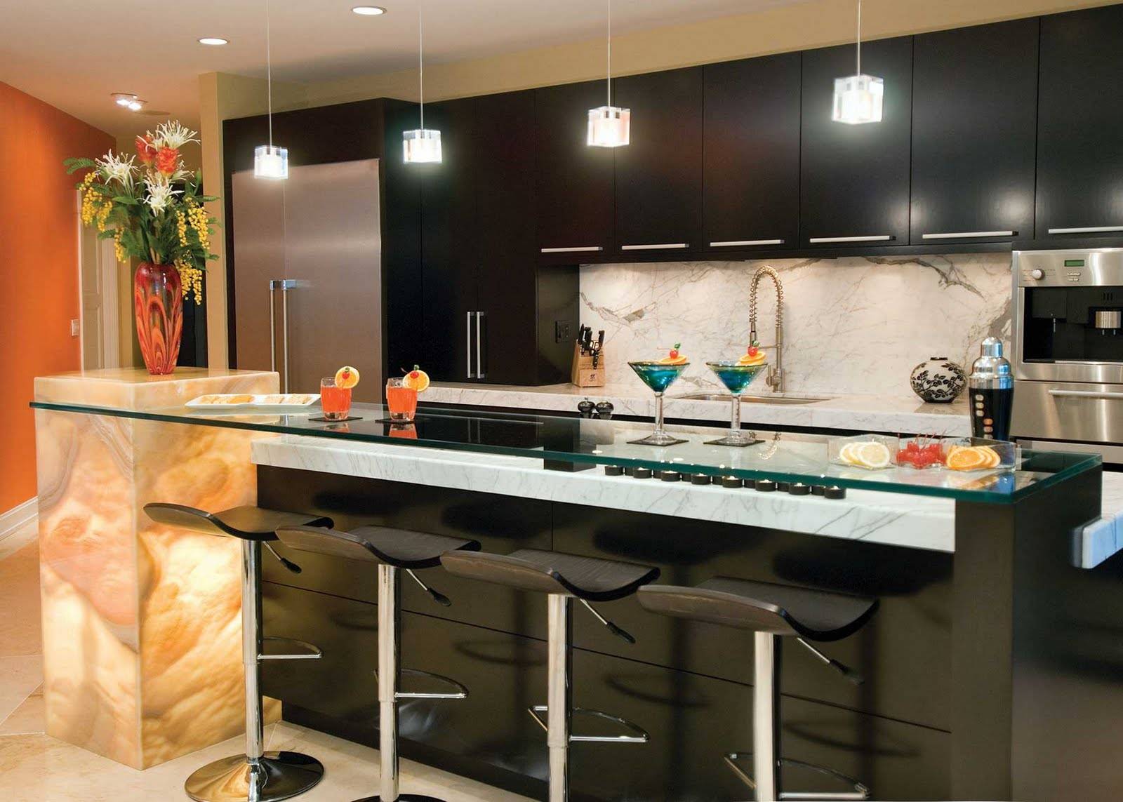 Spectacular black decorated kitchen zone with the island having glass top
