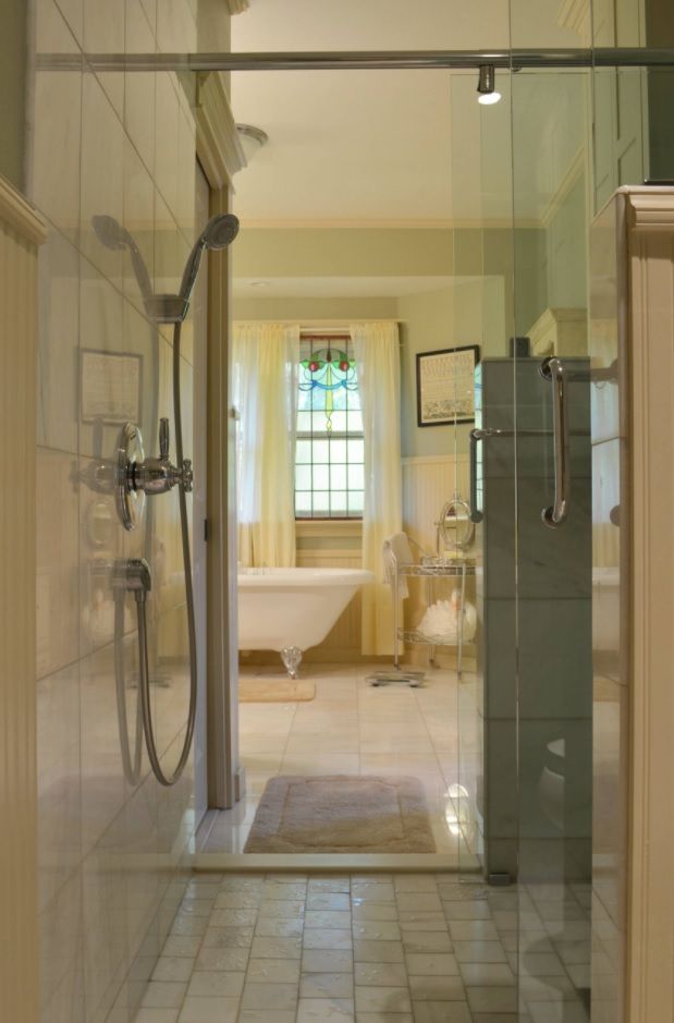 Classic white decorated interior with glossy tile surfaces and separated shower zone