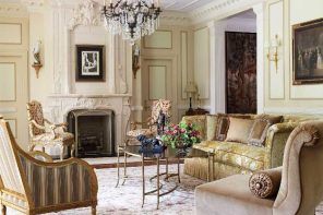 Restrained chic stucco and moldings in light Classic Italian living with fireplace