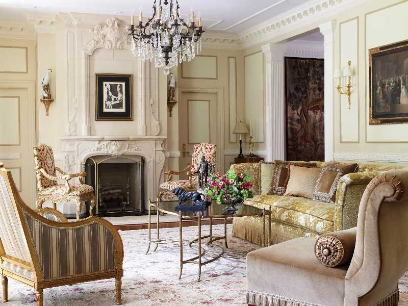 Restrained chic stucco and moldings in light Classic Italian living with fireplace