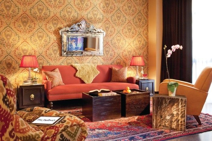 Wallpapern with drawing in golden tint with Classic reddish sofa under the mirror