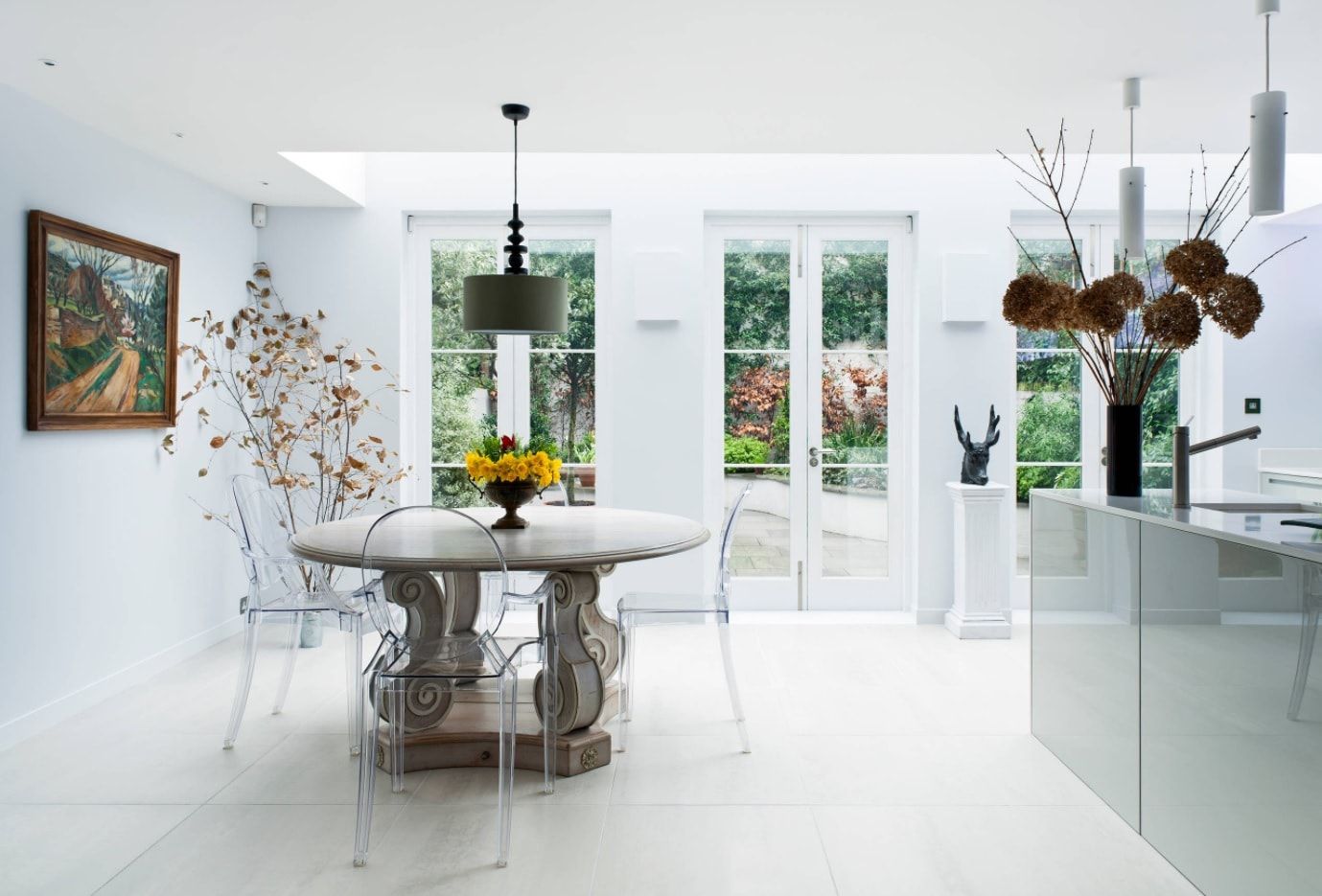Modern plexiglass chairs for the neat white dining zone