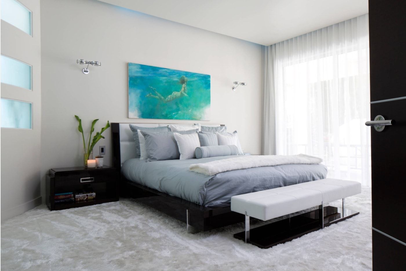 Monochromatic modern bedroom with bright picture at the headboard