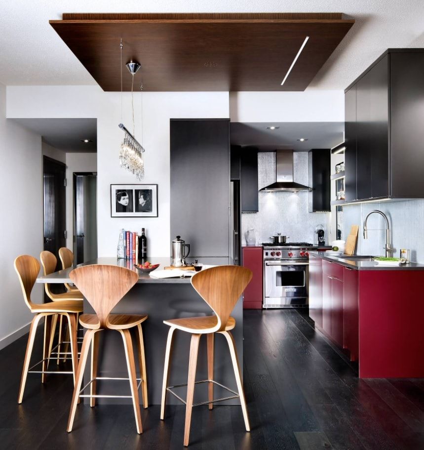 Dining group for modern interior with red kitchen island and dark ceiling