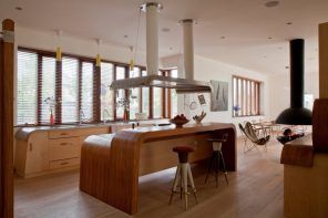 Spectacular arched wooden laminated kitchen island at the center