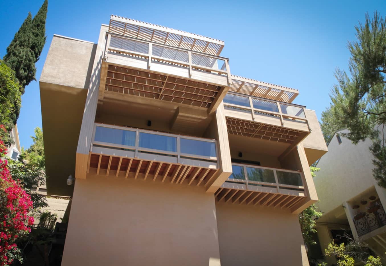 System of wooden balconies at the facade of the sandy colored house