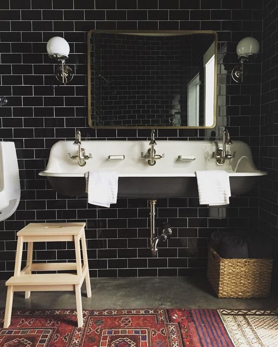 Classic bathroom with large vanity and black tile with light grout