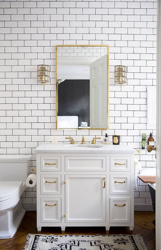 Classic design in the bathroom with golden inlays of the furniture