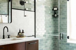 Bluish subway tile in the frameless shower cabin