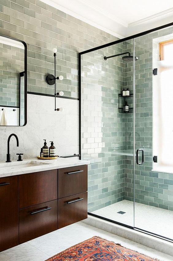 Bluish subway tile in the frameless shower cabin