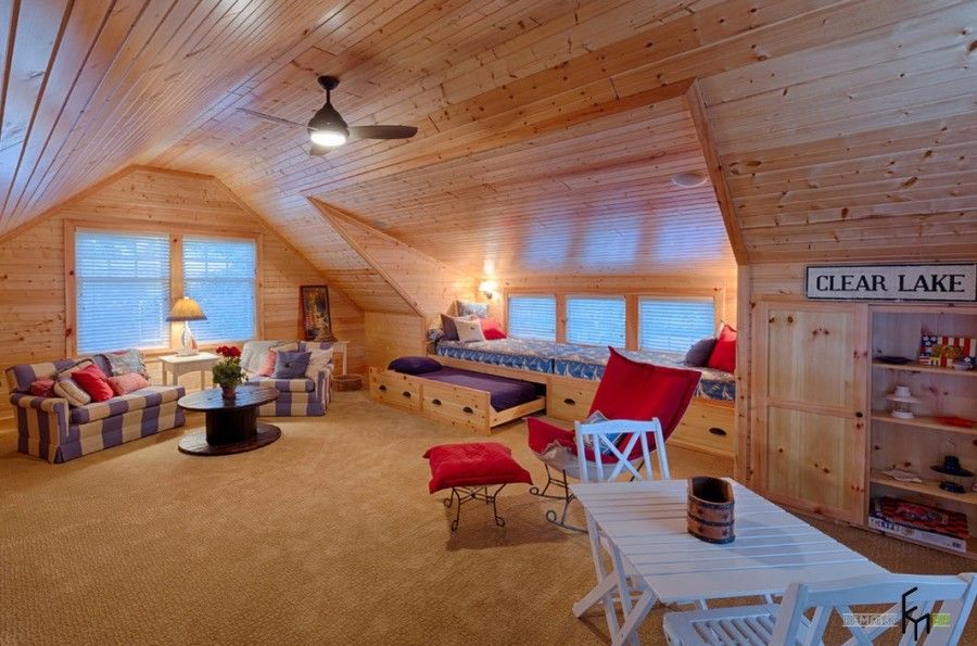 Totally wooden trimming of the modern designed bedroom at the attic with carpeting