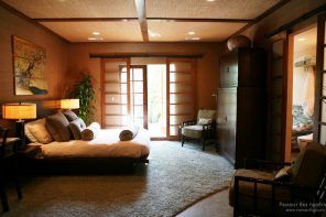 Typical Japanese interior of the bedroom with bonsai, sliding doors and light wooden palette