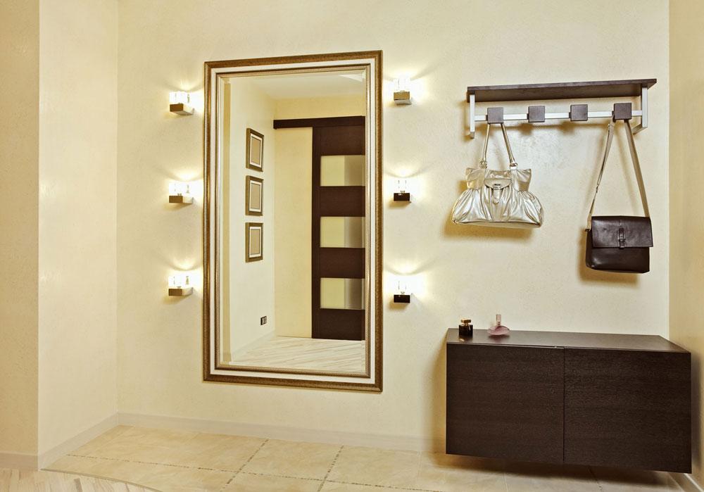 Entrance with sconces around the mirror