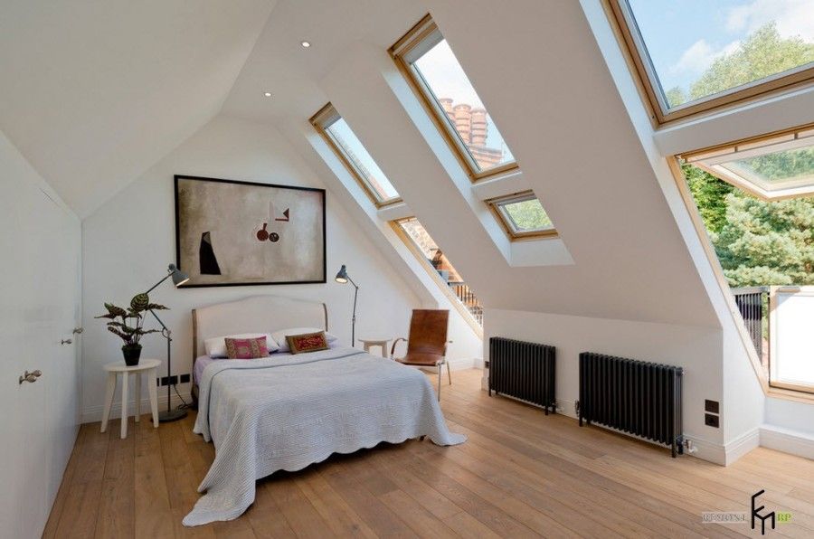 Large attic turned into spectacular modern bedroom with the entrance to balcony