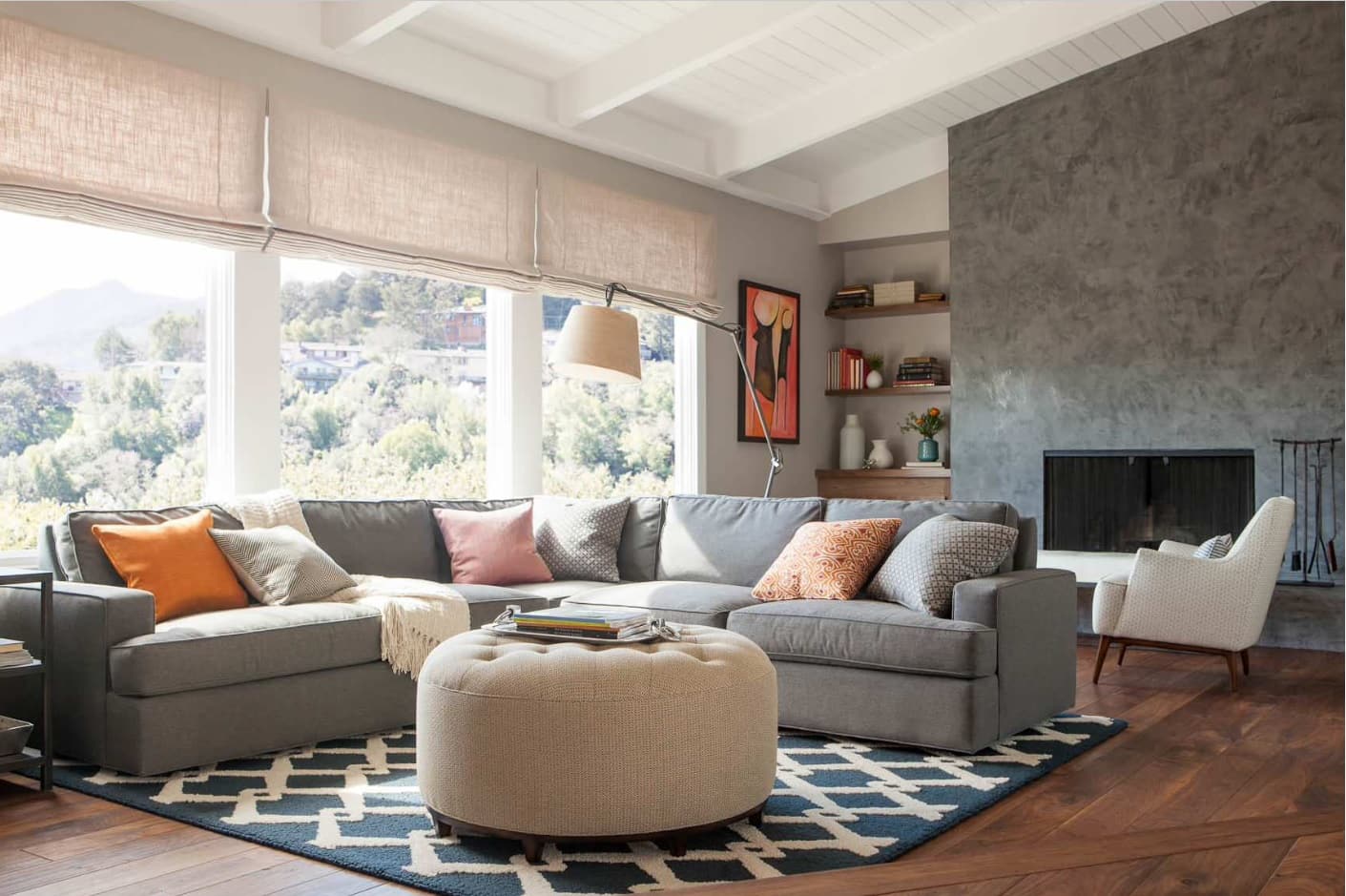 Casual interior with upholstered ottoman as coffee table