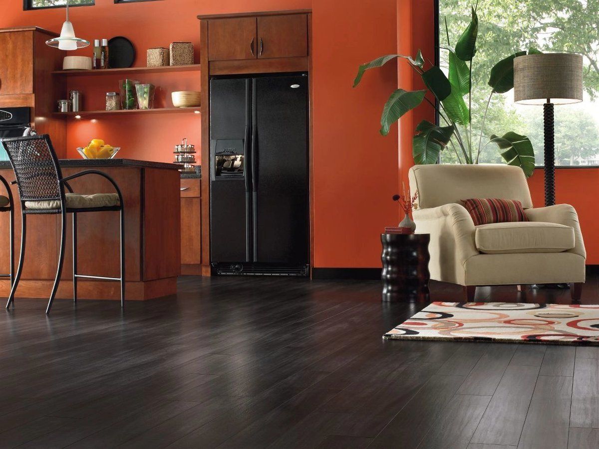 Black wooden floor and orange walls for modern styled kitchen