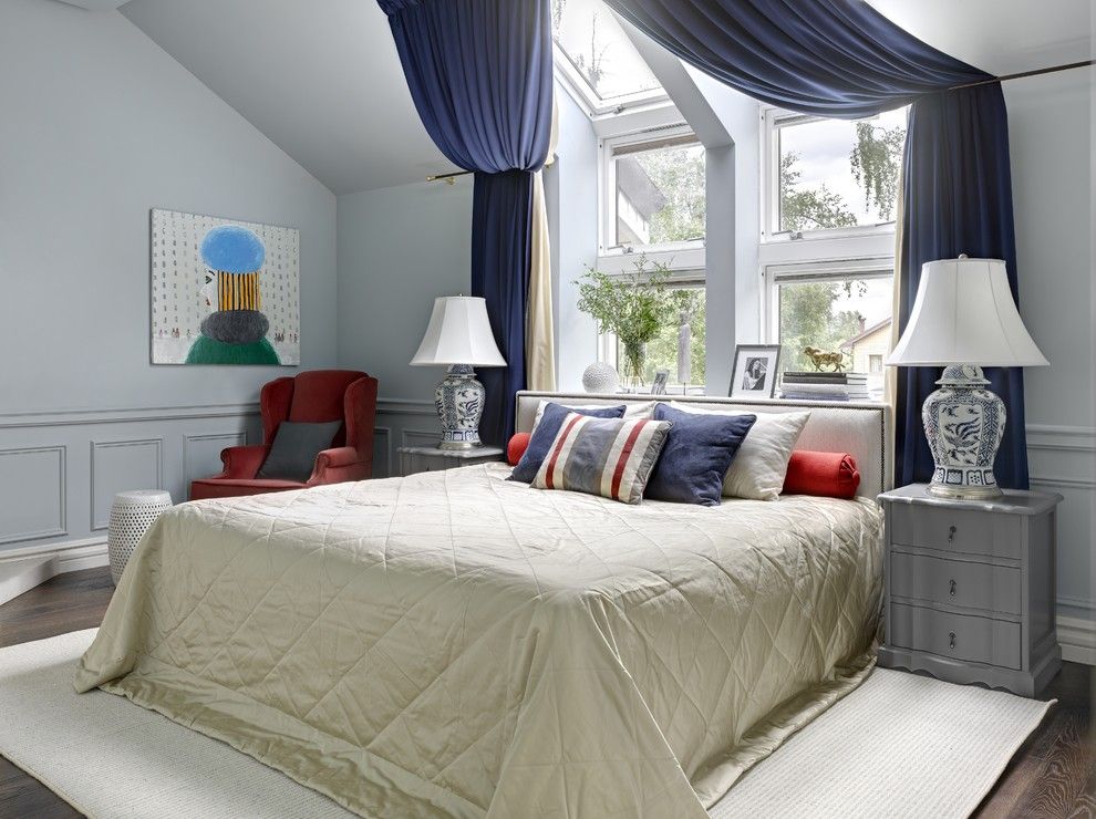 Blue colored drapes at the large complex formed window in the kids' bedroom