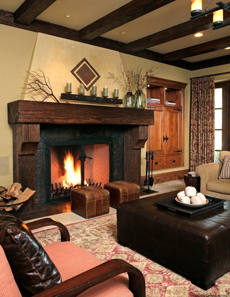 Wooden mantelshelf and sandy colored walls for decoration of the fireplace