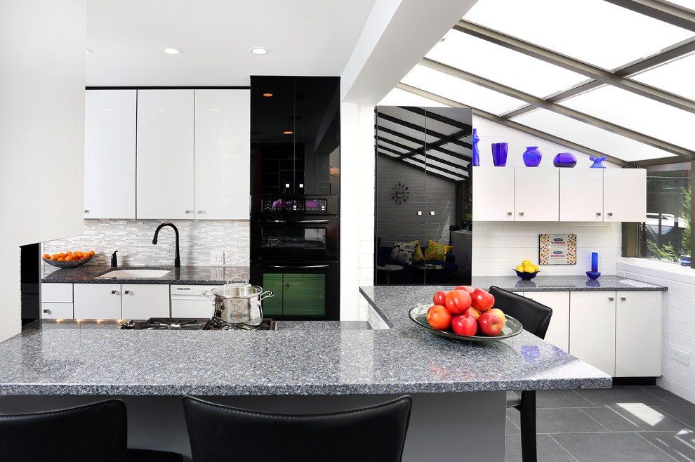 Sunroom next to the kitchen in ultramodern style with dark glass surfaces of appliances